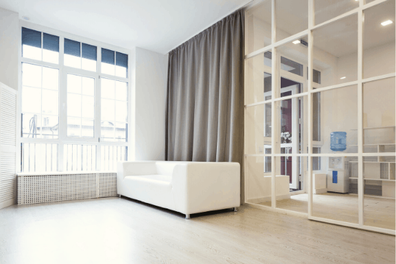 soundproof room divider curtain behind a sofa, covering from ceiling to floor. Grey color and completely blackout
Sound proof wall divider and sound blocking, sound absorbing properties