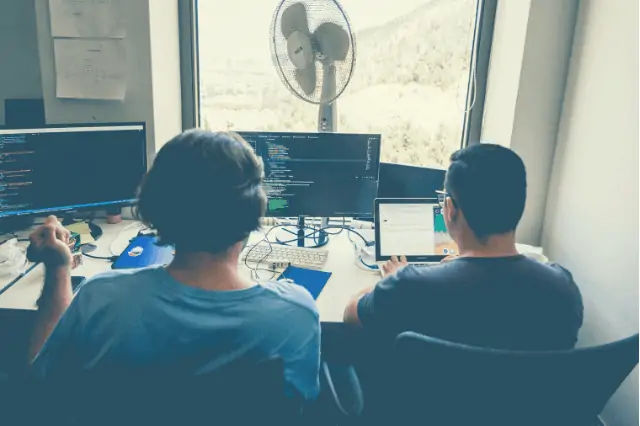 People working with a quiet desk fan