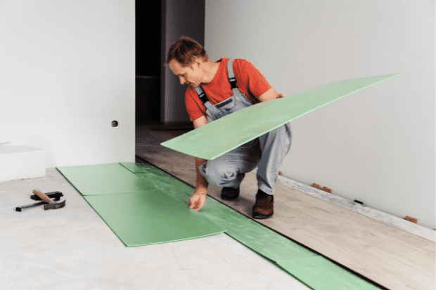 Image showing a man installing floor underlayment.