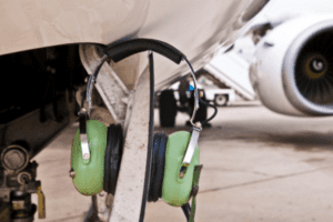 Heaphone on a latch of an aircraft
