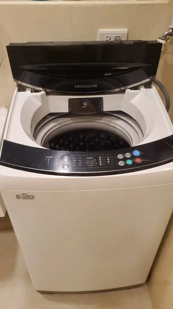 Photo of a top load washer installed in a bathroom