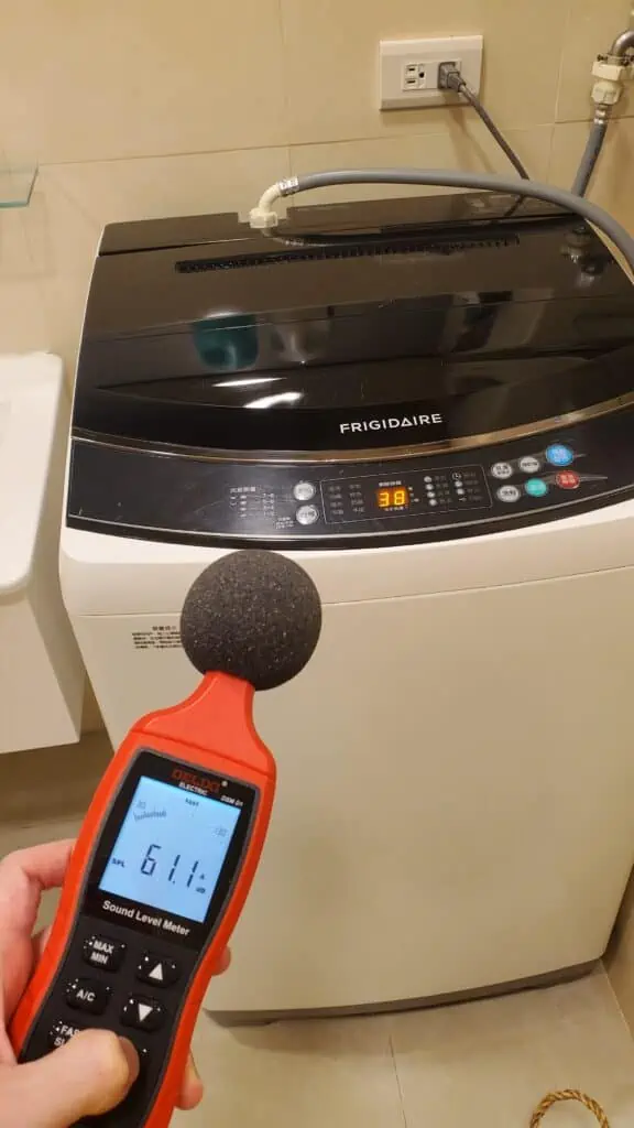 Photo of me (Ludovic Chung-Sao) measuring noise level of a top load washer during water filling.