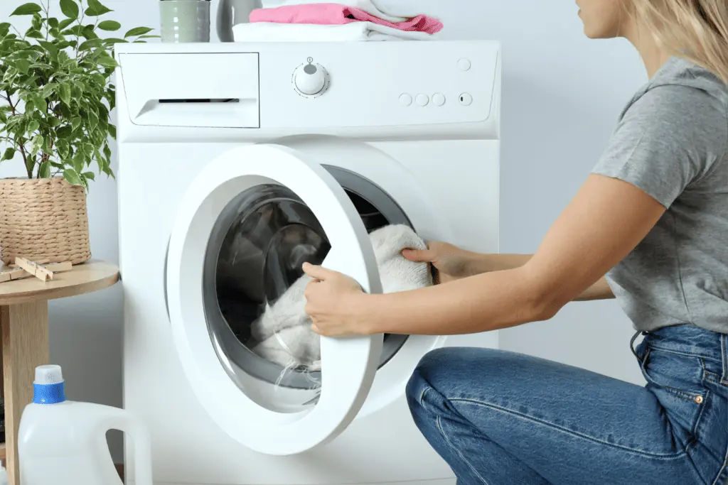 Photo of a woman unloading a front load washer