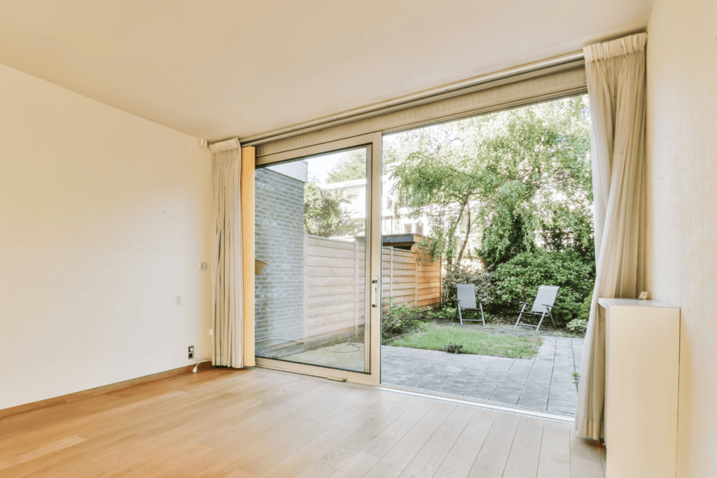 Add curtains over a sliding glass door for soundproofing