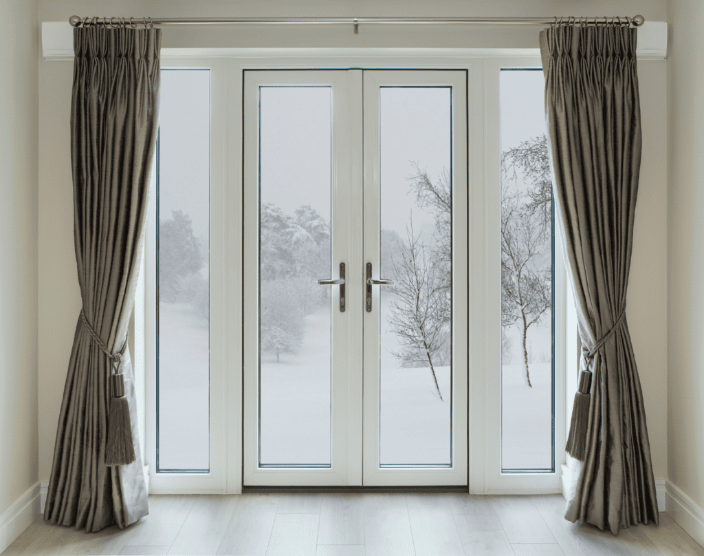 Soundproof curtains in front of a hinged french doors