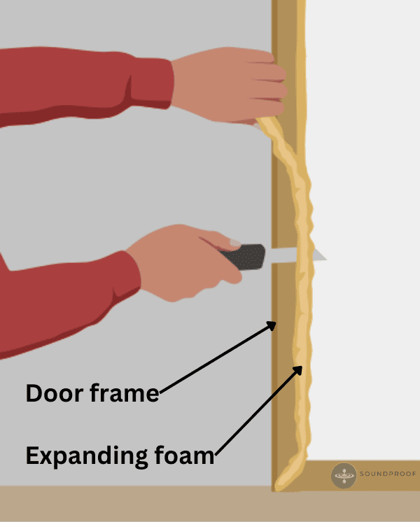 Man cutting the excess of expanding foam around a door frame